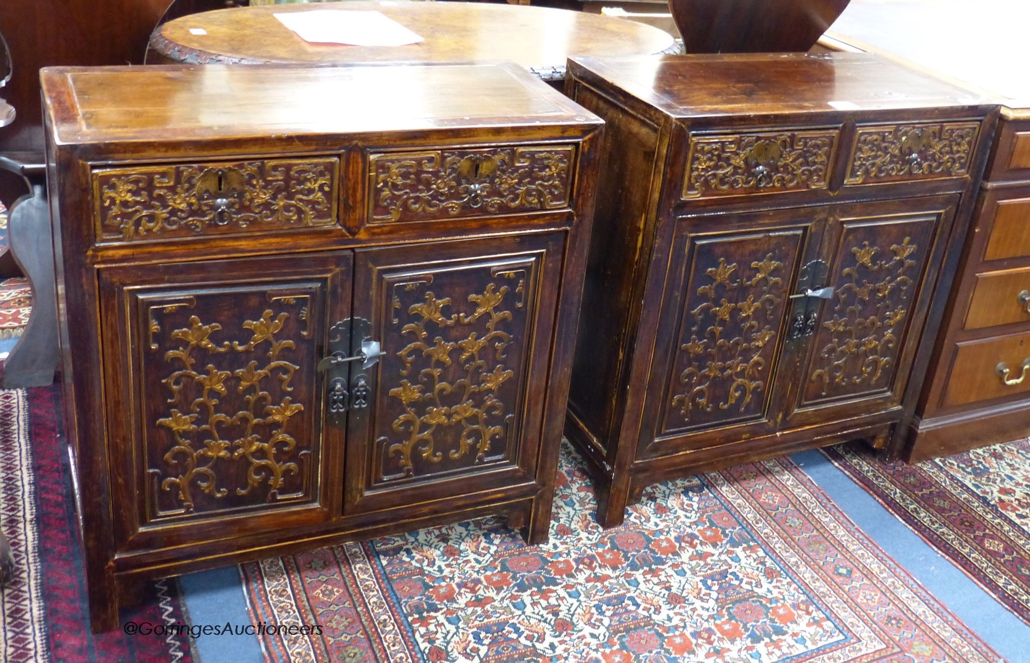 A pair of Chinese carved cabinets, the fronts carved with foliage in low relief, width 69cm, depth 33cm, height 76cm